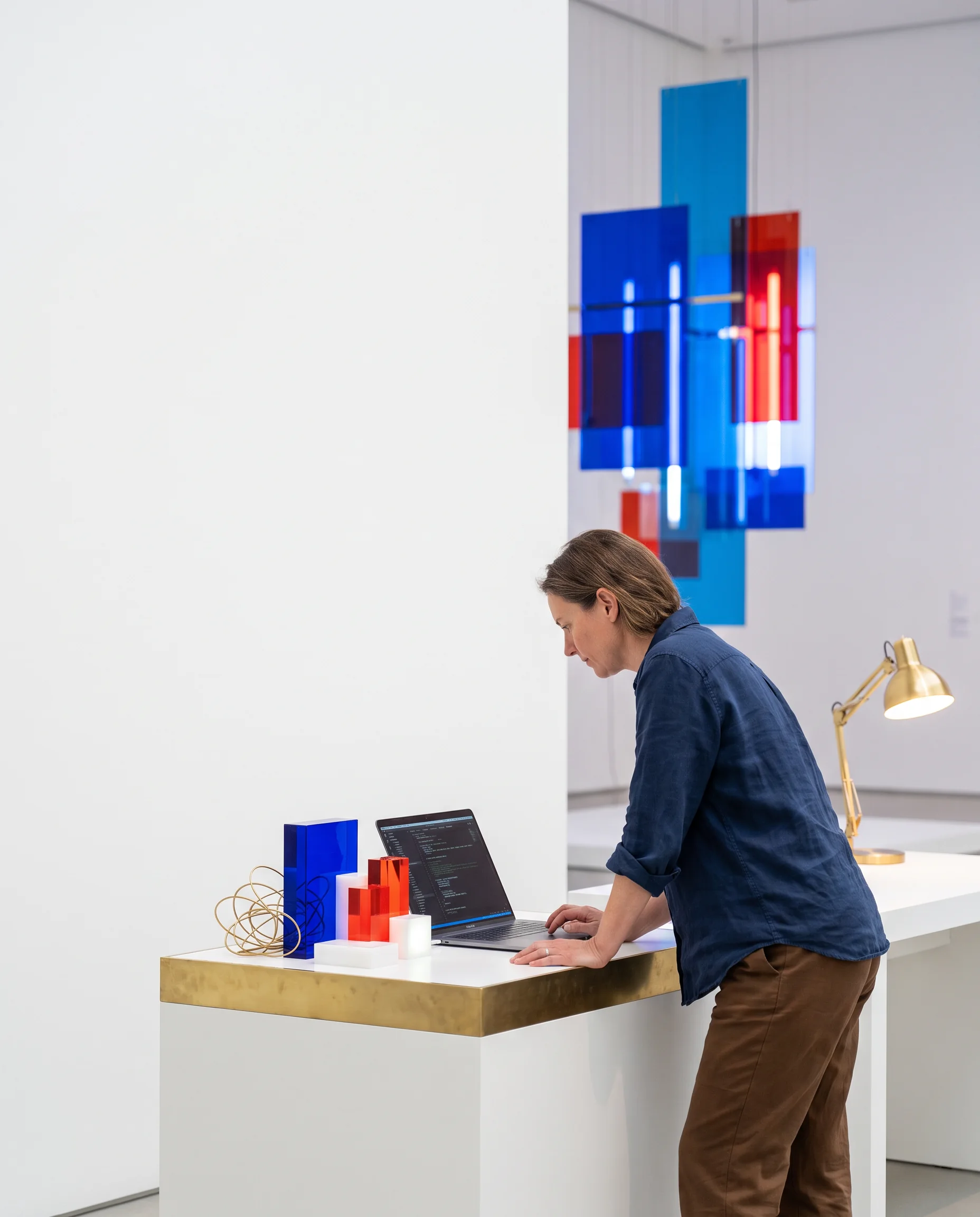 A maker arranging a small exhibition display