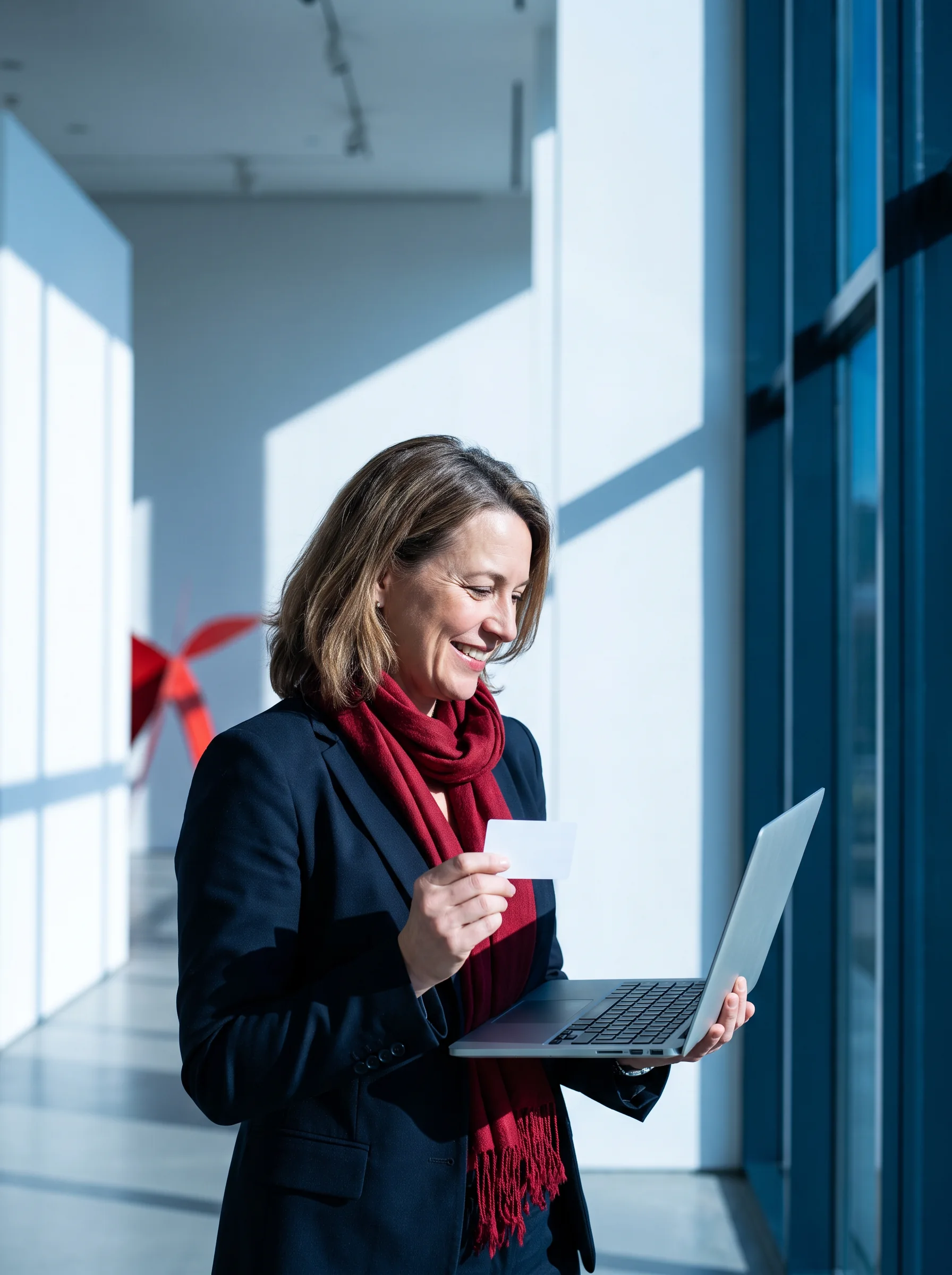 Person making notes beside a laptop